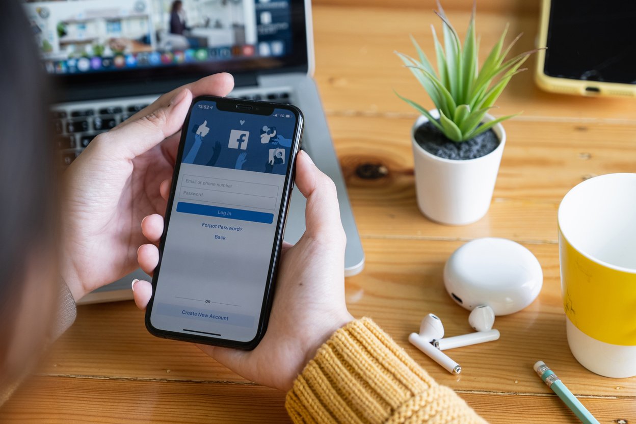 CHIANGMAI, THAILAND - JUNE 29, 2020 : Asian Woman Holds Smartphone with Facebook Login Screen. Facebook Is a Photo-Sharing and E-Commerce Shopping Business.